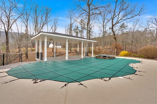 view of swimming pool featuring a patio area, a fenced in pool, an in ground hot tub, and fence