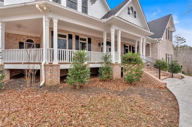 view of home's exterior with brick siding and covered porch