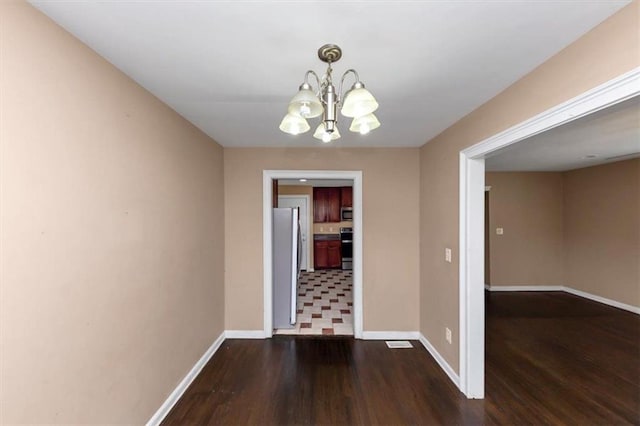 2702 Rollingwood Ln SE, Atlanta, GA 30316 - unfurnished dining area featuring dark wood-style flooring and a chandelier