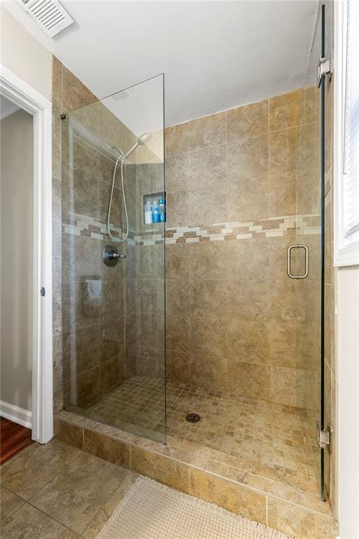 full bath with a shower stall