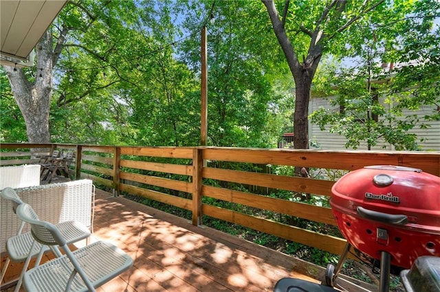 wooden deck with a grill