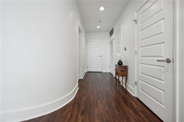 hallway featuring recessed lighting, baseboards, and dark wood finished floors