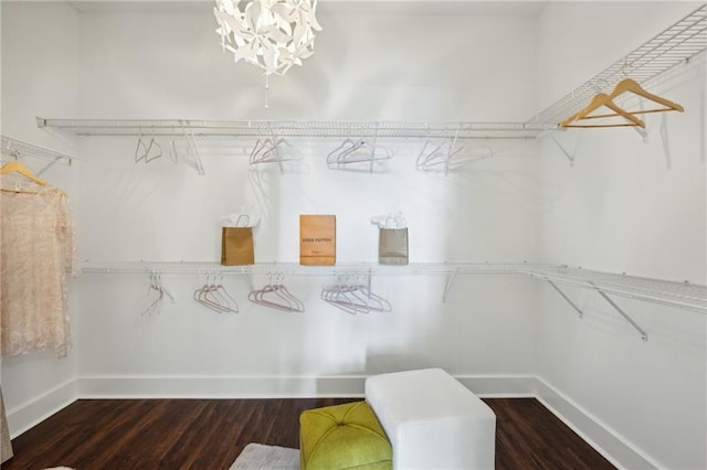 spacious closet featuring a chandelier and wood finished floors