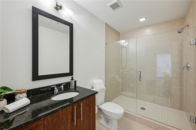 bathroom with tile patterned flooring, visible vents, a shower stall, toilet, and vanity