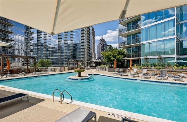 pool with a patio area and a city view