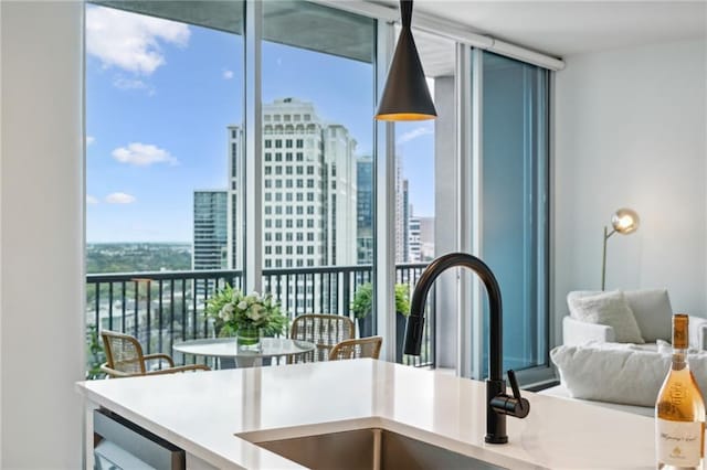 kitchen featuring a sink, expansive windows, and a city view