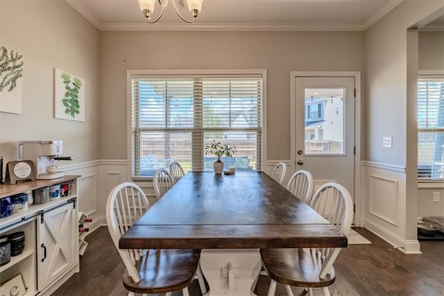 dining space with ornamental molding, dark wood-type flooring, and a notable chandelier