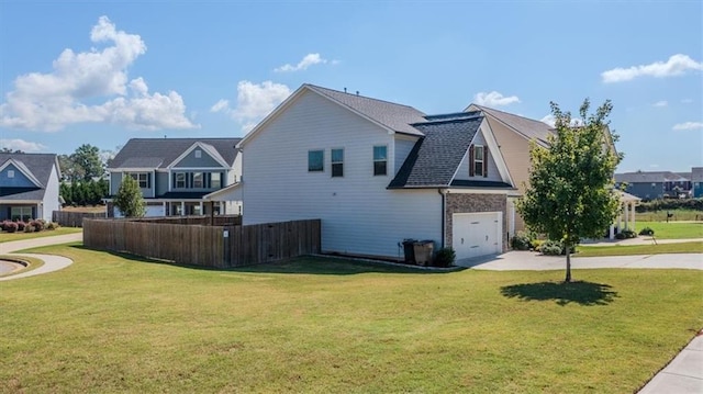 view of home's exterior with a yard and a garage