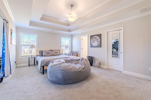 carpeted bedroom featuring ornamental molding and a raised ceiling