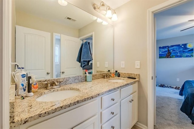 bathroom with ceiling fan and vanity