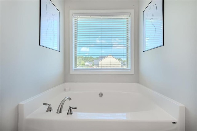 bathroom featuring a healthy amount of sunlight and a bathtub