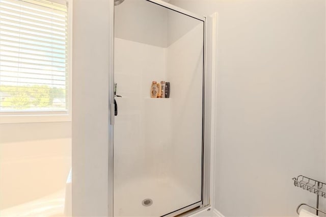 bathroom featuring independent shower and bath