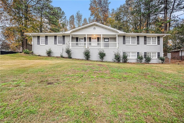 ranch-style home with covered porch and a front yard