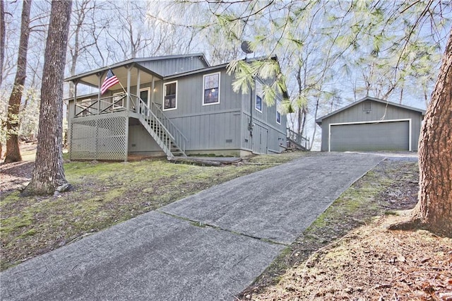 view of front facade with covered porch, a garage, and an outdoor structure