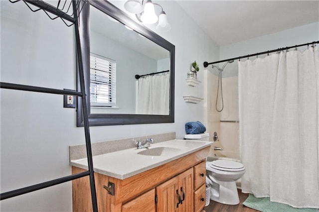 full bathroom with toilet, hardwood / wood-style flooring, vanity, and shower / bath combo with shower curtain