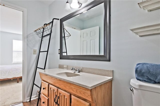 bathroom featuring toilet and vanity