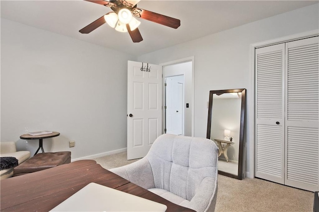 carpeted office space with ceiling fan