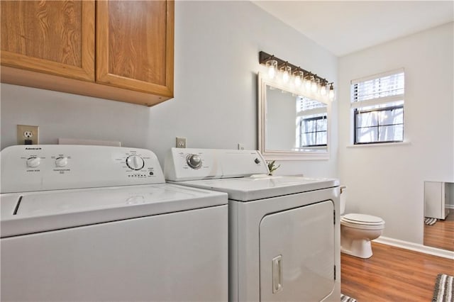 laundry room with washer and clothes dryer and wood-type flooring