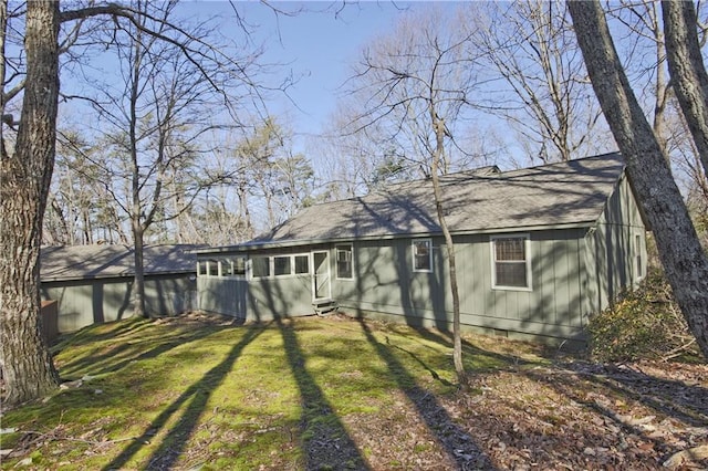 rear view of house featuring a lawn