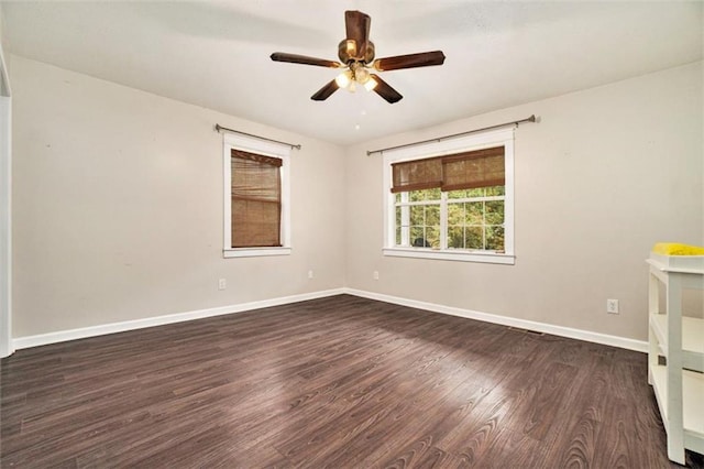 unfurnished room with ceiling fan and dark hardwood / wood-style flooring