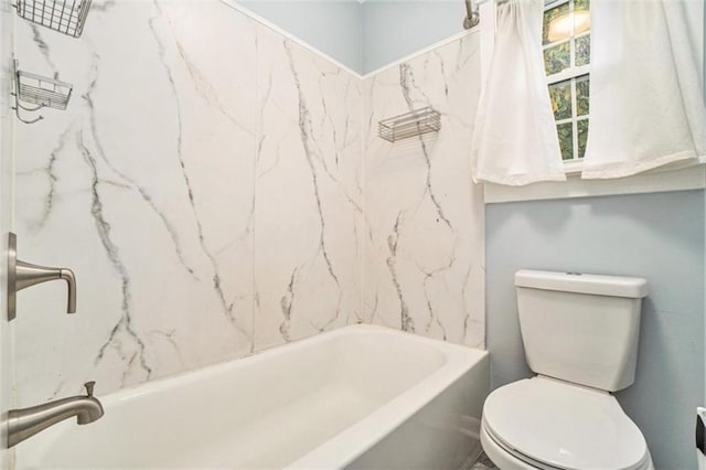 bathroom with shower / tub combination and toilet