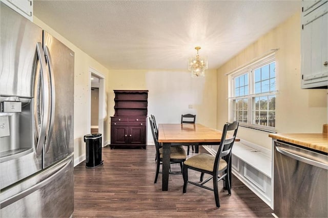 dining area featuring dark hardwood / wood-style floors and a chandelier