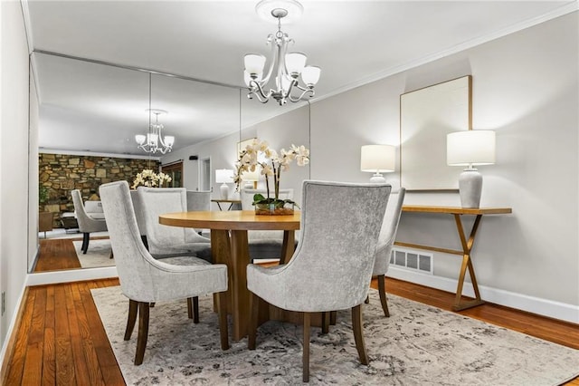 1075 Winding Branch Ln, Atlanta, GA 30338 - dining room with a chandelier, ornamental molding, hardwood / wood-style flooring, and baseboards