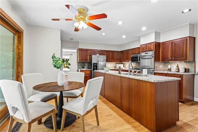 1075 Winding Branch Ln, Atlanta, GA 30338 - kitchen with appliances with stainless steel finishes, backsplash, a ceiling fan, light wood-style floors, and recessed lighting