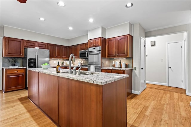 1075 Winding Branch Ln, Atlanta, GA 30338 - kitchen with a sink, appliances with stainless steel finishes, backsplash, light wood finished floors, and recessed lighting