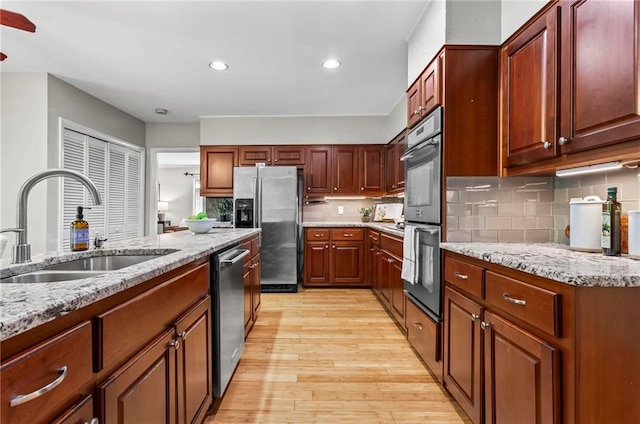 1075 Winding Branch Ln, Atlanta, GA 30338 - kitchen featuring a sink, appliances with stainless steel finishes, light wood-style flooring, light stone countertops, and backsplash