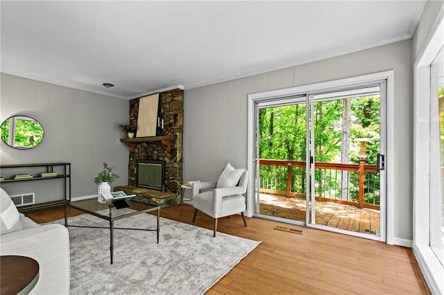 1075 Winding Branch Ln, Atlanta, GA 30338 - living area featuring crown molding, a stone fireplace, and wood finished floors