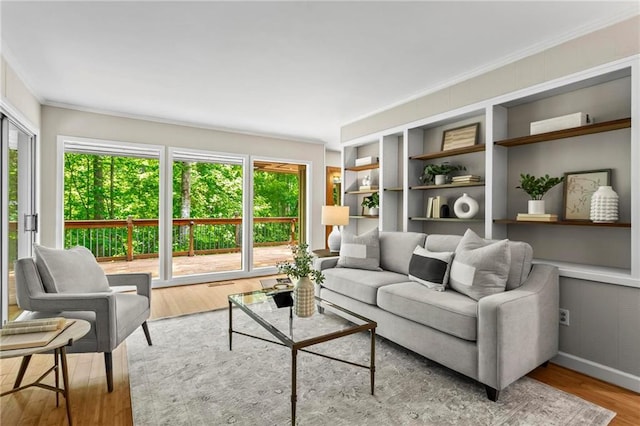 1075 Winding Branch Ln, Atlanta, GA 30338 - living area with ornamental molding, healthy amount of natural light, wood finished floors, and built in shelves