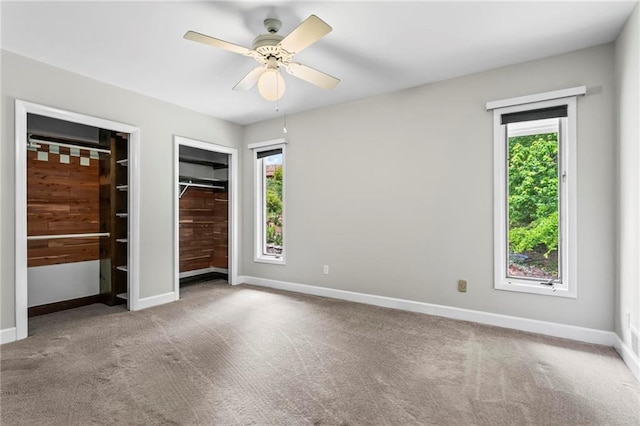 1075 Winding Branch Ln, Atlanta, GA 30338 - unfurnished bedroom with multiple closets, multiple windows, carpet flooring, and baseboards