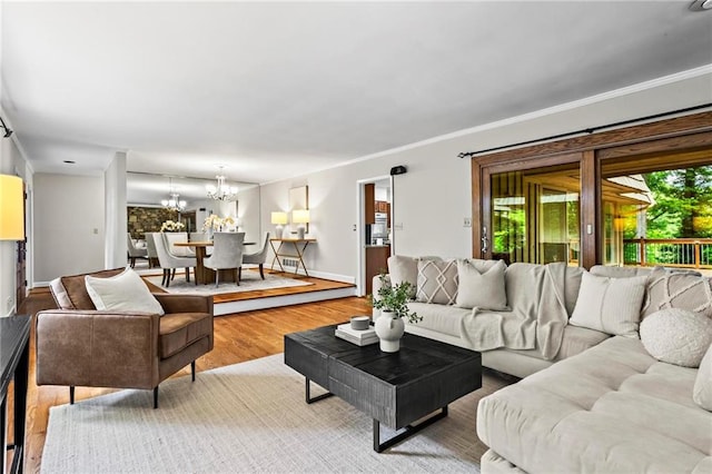 1075 Winding Branch Ln, Atlanta, GA 30338 - living area with a chandelier, wood finished floors, baseboards, and crown molding
