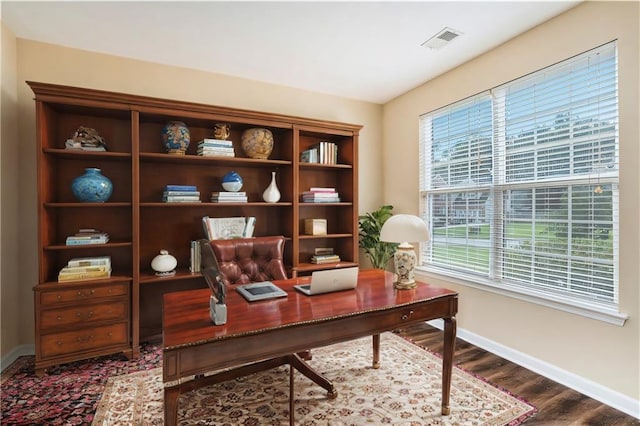 office space with visible vents, baseboards, and wood finished floors