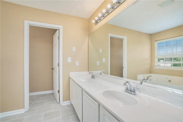 bathroom featuring double vanity, baseboards, a sink, and a bath