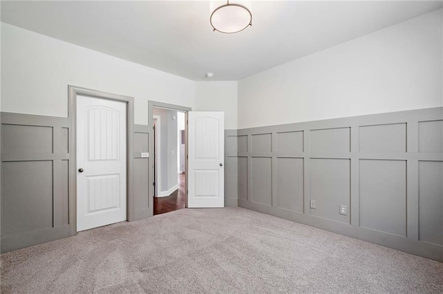 4460 Hunters Walk Way, Cumming, GA 30028 - unfurnished bedroom featuring carpet floors, a decorative wall, and a wainscoted wall