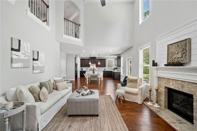 4460 Hunters Walk Way, Cumming, GA 30028 - living area featuring dark wood-type flooring, a glass covered fireplace, and a high ceiling