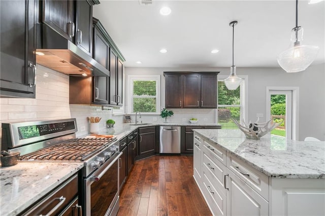 4460 Hunters Walk Way, Cumming, GA 30028 - kitchen featuring stainless steel appliances, light stone countertops, dark wood finished floors, decorative backsplash, and recessed lighting