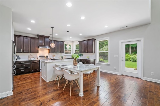 4460 Hunters Walk Way, Cumming, GA 30028 - kitchen featuring stainless steel range oven, dark brown cabinetry, a center island, decorative backsplash, and dark wood-style floors