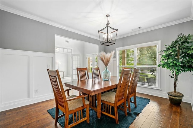 4460 Hunters Walk Way, Cumming, GA 30028 - dining space featuring a chandelier, dark wood-type flooring, a decorative wall, and ornamental molding