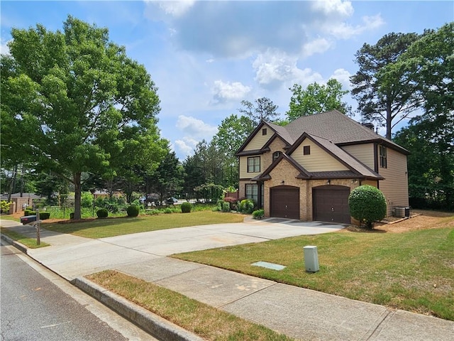 view of front of property with an attached garage, concrete driveway, a front lawn, central air condition unit, and brick siding