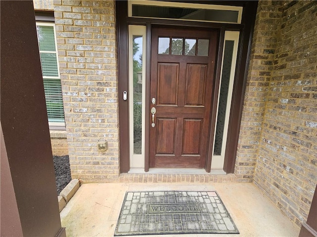 property entrance with brick siding