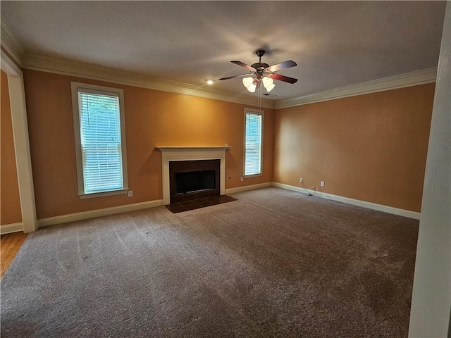 unfurnished living room with crown molding, baseboards, a ceiling fan, and a healthy amount of sunlight