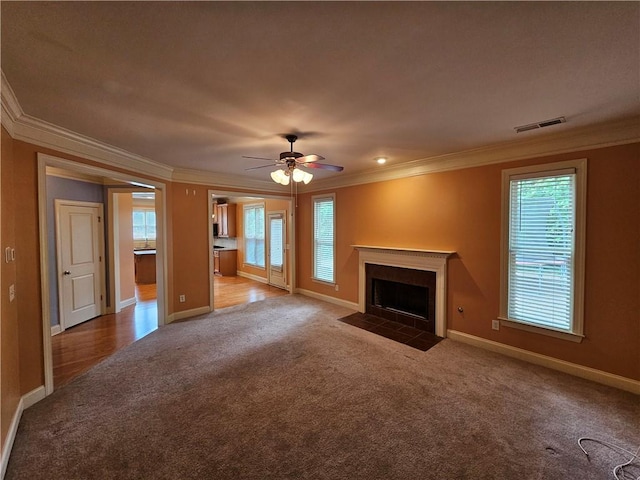 unfurnished living room featuring crown molding, carpet, baseboards, and visible vents