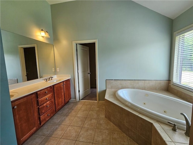 bathroom featuring a wealth of natural light, tile patterned floors, a sink, and a whirlpool tub