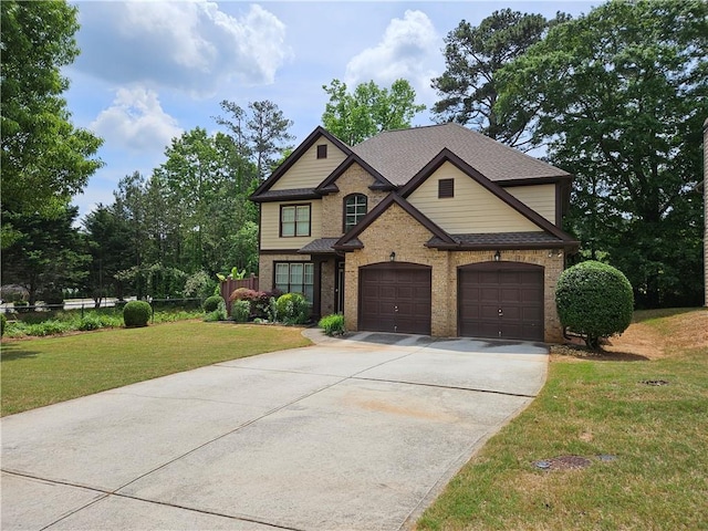 craftsman-style home featuring driveway, brick siding, fence, a shingled roof, and a front lawn