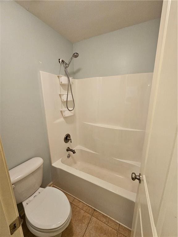 bathroom with toilet, tub / shower combination, and tile patterned floors