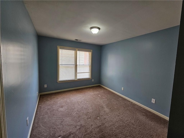 unfurnished room featuring visible vents, baseboards, and carpet floors