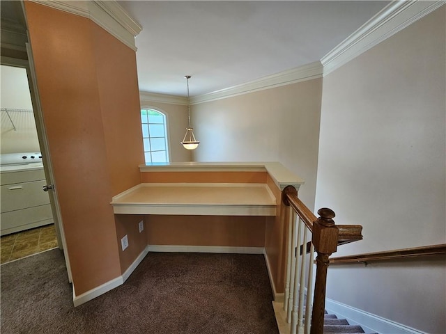 corridor featuring baseboards, ornamental molding, washer / dryer, and carpet floors